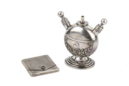 A Continental silver matchbook holder and a white metal table lighter.
