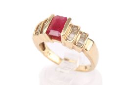 A yellow metal, ruby and diamond dress ring. Set with one emerald cut ruby of 0.