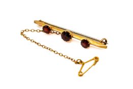 A 9ct gold and garnet bar brooch.