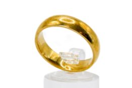 An 18ct gold wedding band. Width 6mm, hallmarked, size V/W, weight 9.7g.