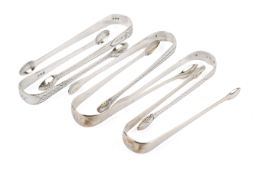 Six Georgian silver sugar tongs.