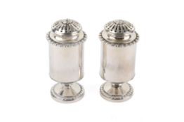 A pair of Georgian silver pounce or pepper pots.
