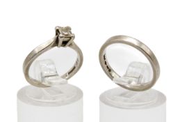 A platinum diamond solitaire ring and matching wedding band. The princess cut diamond of 0.