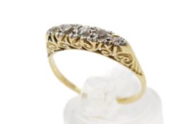 A carved half hoop diamond ring. Set with five old brilliant cut diamonds of 0.