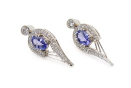 A pair of platinum and tanzanite earrings.