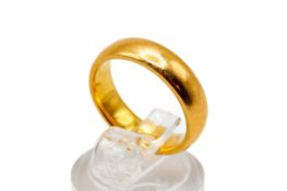 A 22ct gold wedding band. Width 4.5mm, size K, hallmarked, weight 6.6g.
