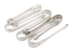 Six Georgian silver sugar tongs.