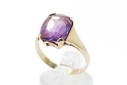 A yellow metal dress ring.