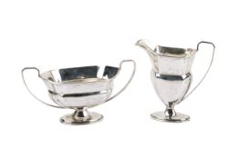 A matching early 20th century silver cream jug and twin-handled sugar bowl.