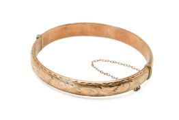 A 9ct hinged bangle.