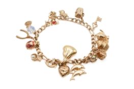 A 9ct gold charm bracelet with 9ct gold and yellow metal charms.