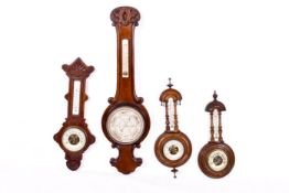 Four various wheel 'banjo' aneroid barometers. Having carved wooden cases.