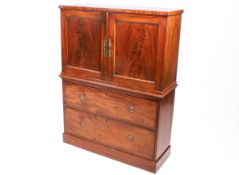 A 19th century mahogany cabinet on chest. Having brass fittings, two door cabinet.