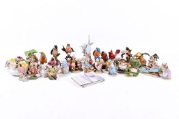 A collection of assorted bird and Beatrix Potter character figurines.