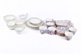 A group of assorted china tea sets, mostly cups and saucers.