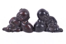Two carved resin Japanese style figures. With a brownish-black finish, height circa 5.5cm.