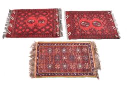 Three small Persian style wool rugs on red grounds. Having borders and geometric motifs.