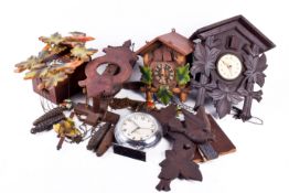 A group of four wooden cased wall clocks.