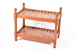 A vintage wooden slatted shelved coffee table with barley twist supports.