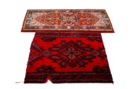 A Caucasian Soumak style wool rug on a red ground, together with a cut down rug.