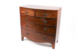 A Georgian bow fronted inlaid mahogany chest of drawers.