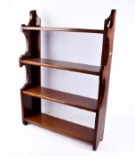 A mahogany freestanding bookcase. Having four shelves.