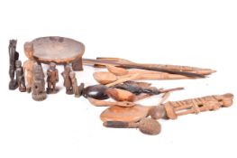A collection of ethnographic carved wooden items, mostly African tribal.