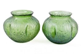 A pair of Art Nouveau style green glass vases.