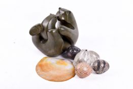 A carved rock crystal in the form of an egg, with three others and a sea shell, etc.