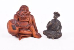 A Japanese fruitwood netsuke signed and a small bronze okimono.