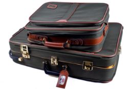A two piece Antler green canvas suitcase luggage set.
