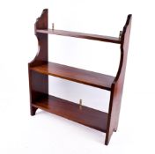 A mahogany freestanding bookcase. Having three fixed shelves.