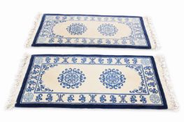A pair of short Chinese runner rugs.