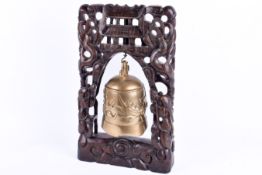A Chinese temple bell. Having heavily carved wooden stand.