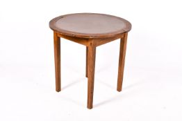An oak circular table with an inset top. Raised on square tapering supports.