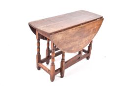 An oak gateleg table with a oval top. H65cm x W103cm x D96cm (open).