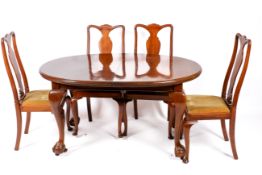 A 1920s period mahogany Queen Anne style extending oval table and six chairs.