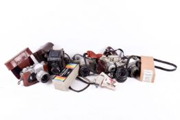 Collection of assorted vintage film cameras and photographic equipment.