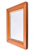 A wall mirror with a maple veneer frame.