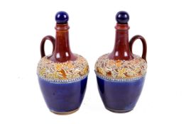 A pair of late 19th or early 20th century Doulton Lambeth stoneware ewers.
