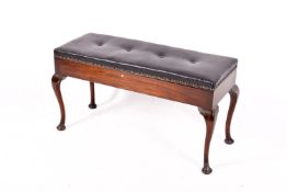 A 20th century mahogany duet piano stool raised on cabriole legs.