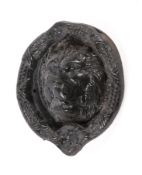 A Victorian cast metal door knocker modelled as a lion mask.