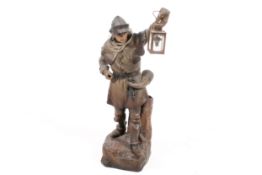 A 20th century Austrian cast metal lamp in form of prison guard holding a lantern.