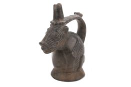 A Pre-Columbian Peruvian blackware chimu vessel in the form of a dog.