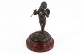 A small bronze model of Cupid.