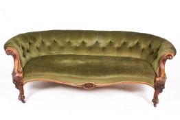 An early 20th century button back kidney shaped sofa.