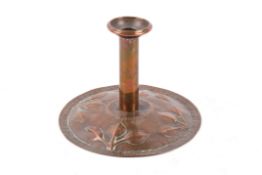 A copper Arts & Crafts candlestick.
