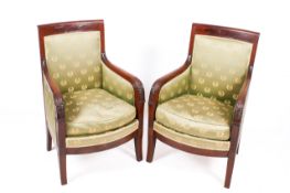 A pair of 19th Century French Empire style mahogany bergere armchairs.