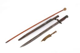 A WWI period Wilkinson bayonet and a Royal Scots cane and a Trench Art knife.