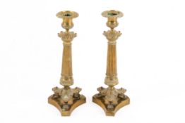 A pair of 19th century French Empire style brass candlesticks.